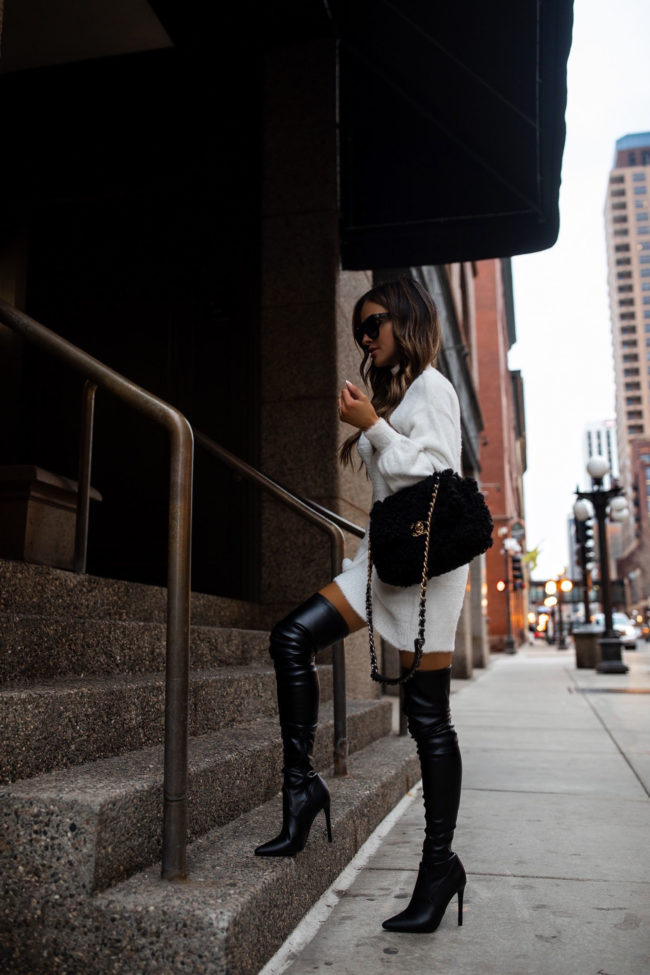 fashion blogger mia mia mine wearing a sweater dress and over the knee boots