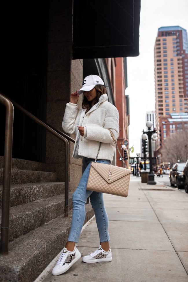 fashion blogger mia mia mine wearing a white puffer jacket and white sneakers from express