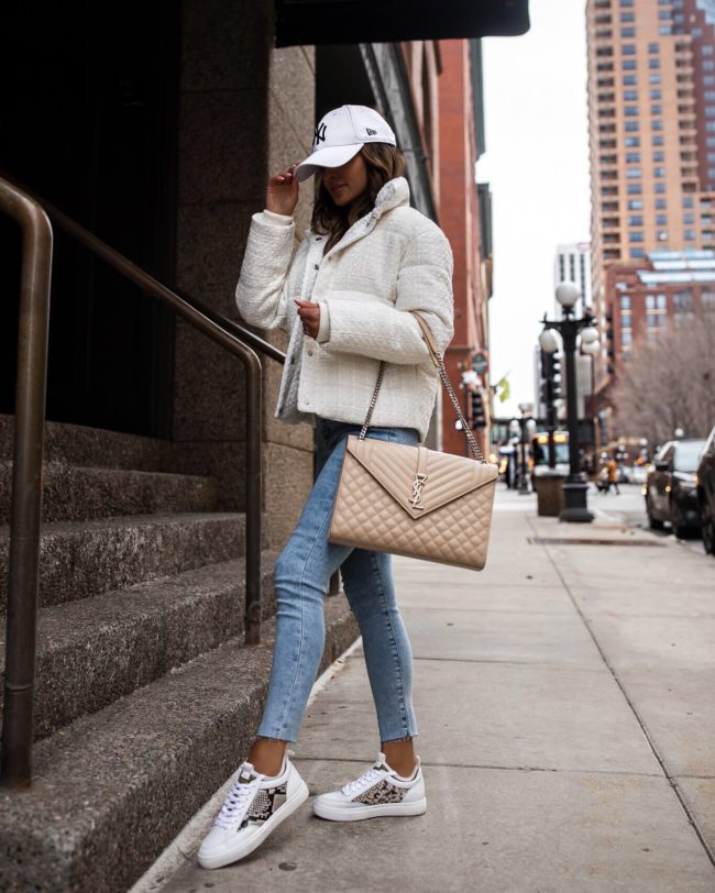 fashion blogger mia mia mine wearing a white puffer jacket and white sneakers from express