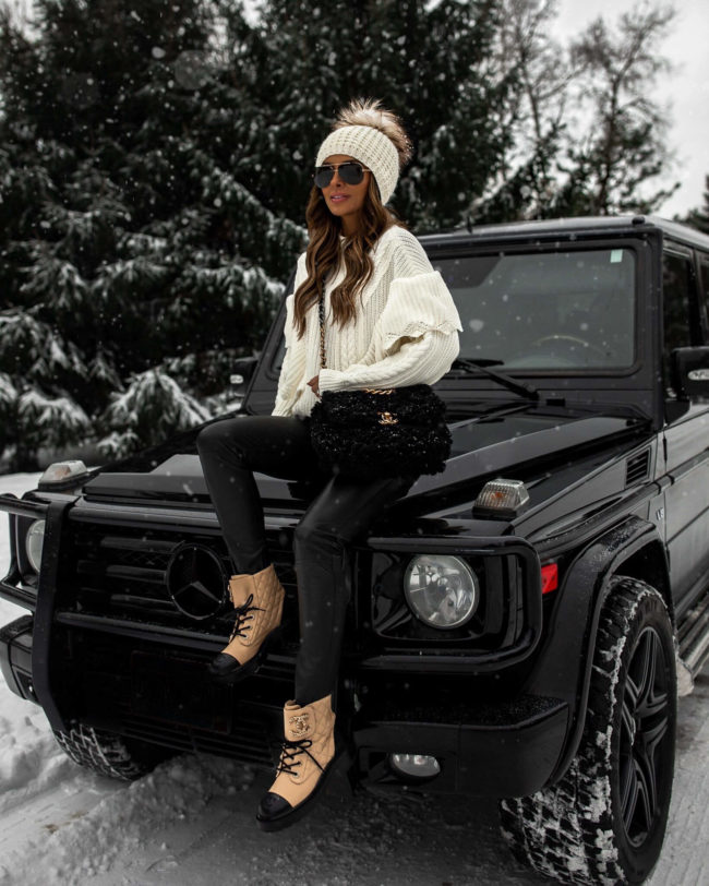 fashion blogger mia mia mine wearing a white sweater from karen millen and chanel combat boots