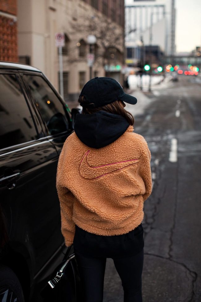 fashion blogger mia mia mine wearing a nike swoosh faux fur jacket 