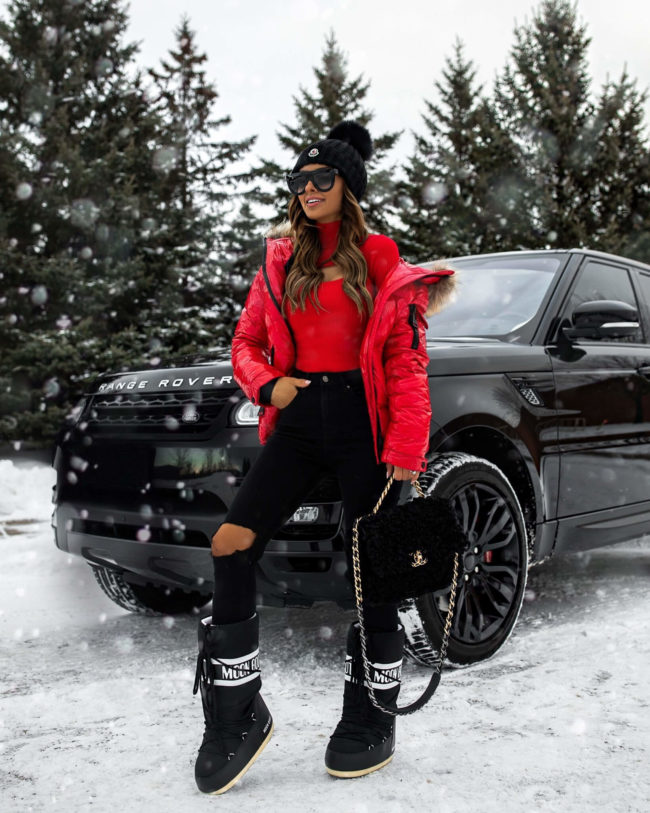 fashion blogger mia mia mine wearing a red sweater from revolve and a moncler beanie