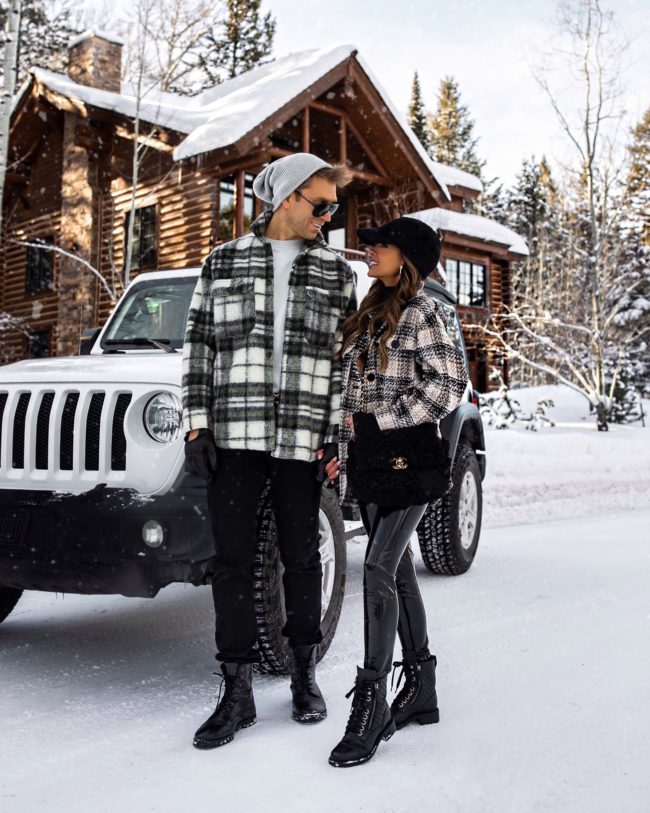 fashion blogger mia mia mine and her husband wearing matching shacket outfits in jackson hole