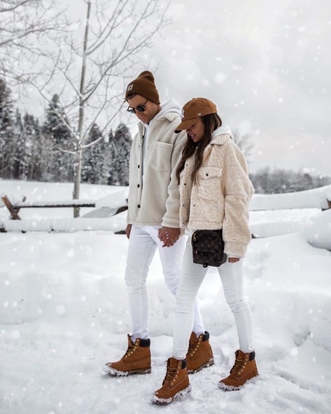 fashion blogger mia mia mine and her husband wearing matching shearling jacket outfits for winter
