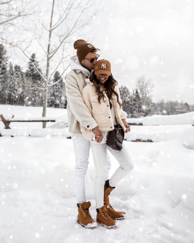 fashion blogger mia mia mine wearing a shearling jacket with her husband in jackson hole