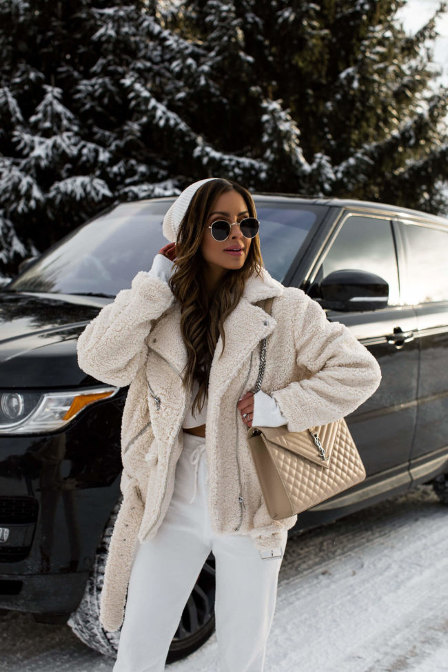 fashion blogger mia mia mine wearing a white beanie and sunglasses from forever 21