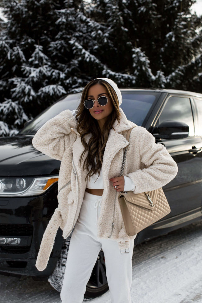 fashion blogger mia mia mine wearing a white loungewear set and a shearling moto jacket from forever 21