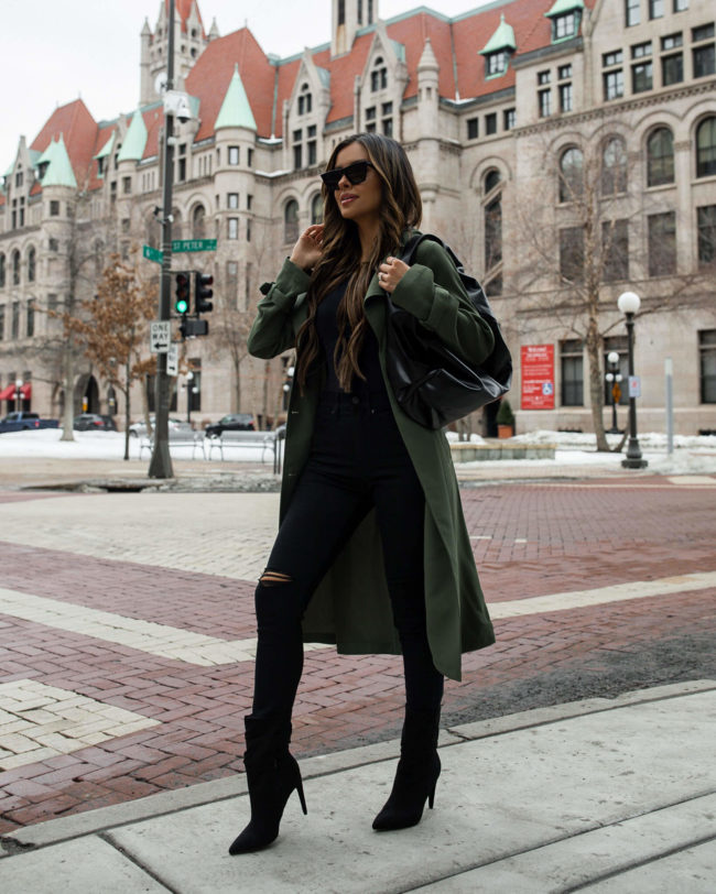 mia mia mine wearing an olive trench coat from express