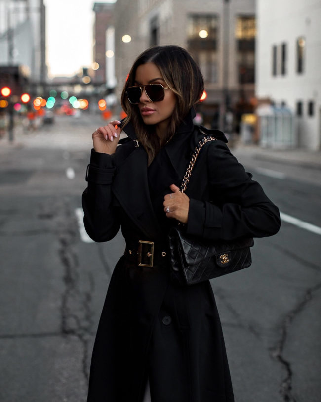 mia mia mine wearing a black trench coat from karen millen