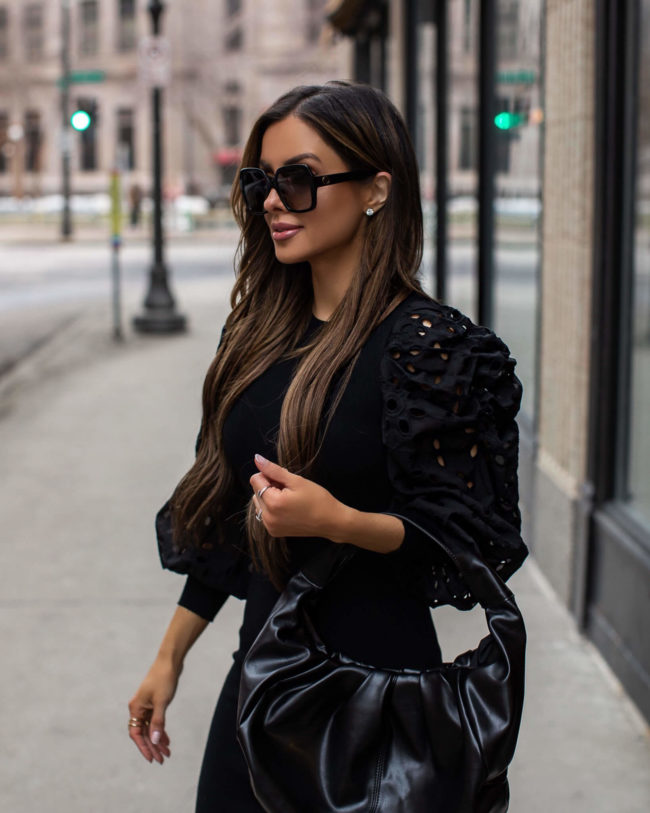 fashion blogger mia mia mine wearing a black express dress for spring