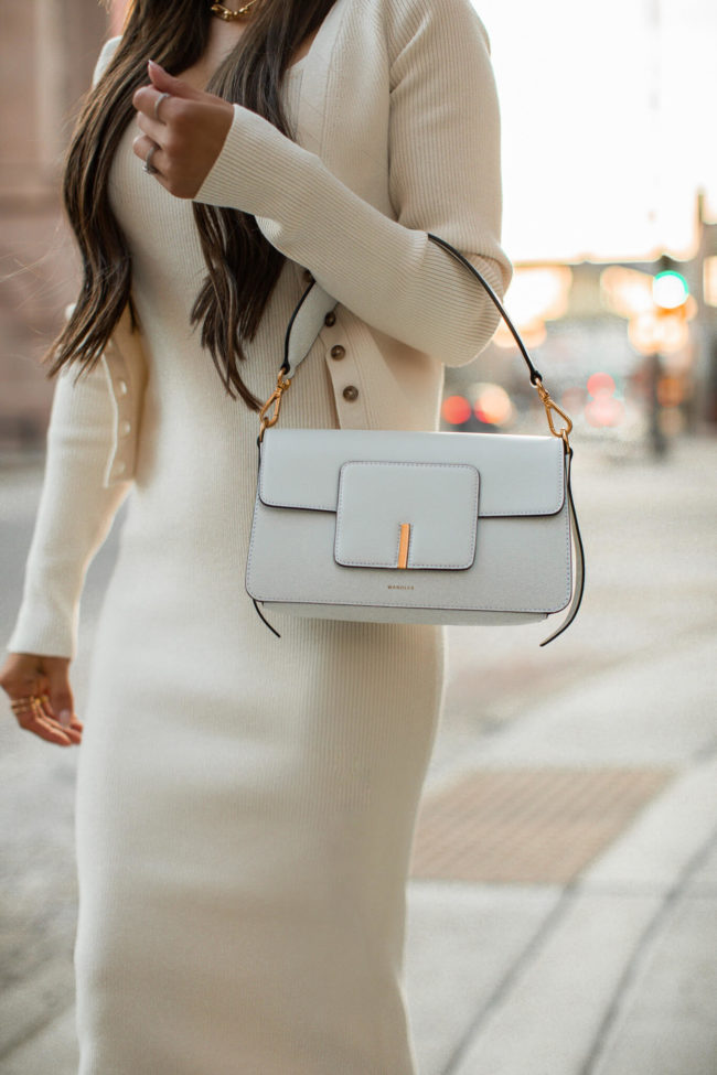 fashion blogger carrying a wandler white bag from intermix