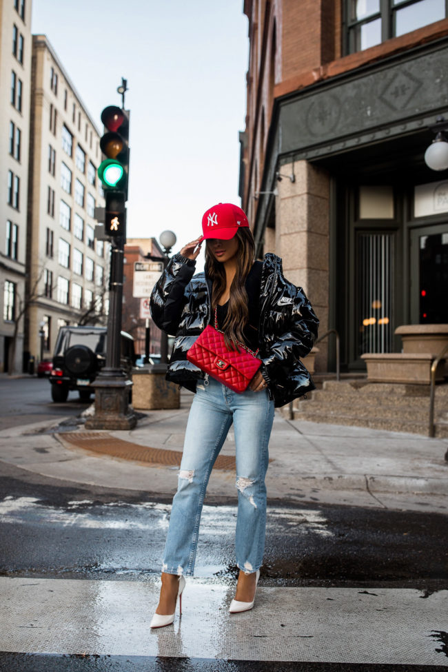 fashion blogger mia mia mine wearing a red ny yankees cap and red chanel bag