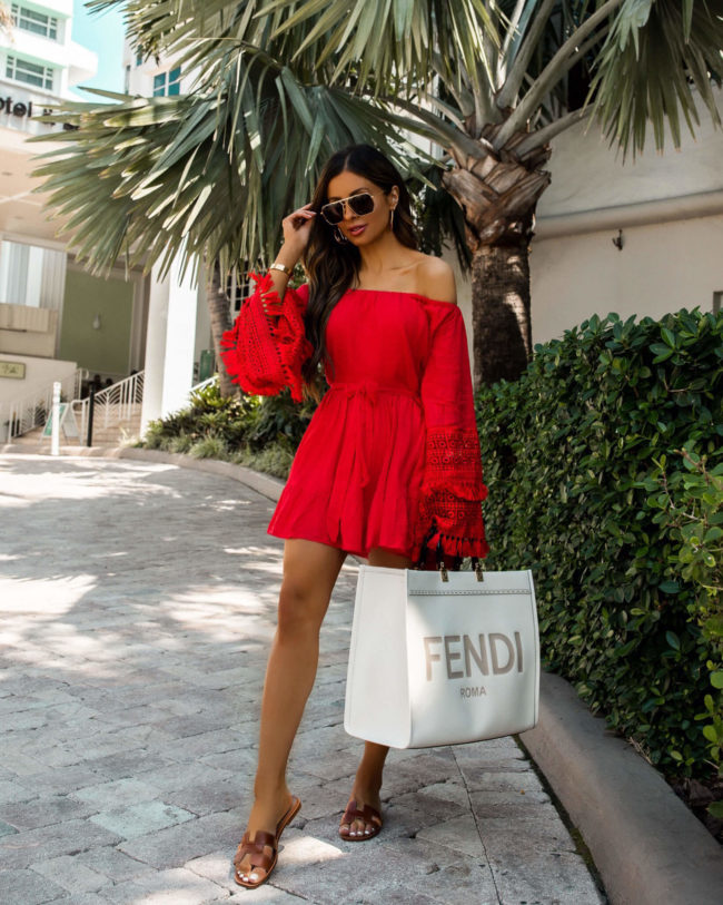 fashion blogger wearing a red dress by judith march in miami