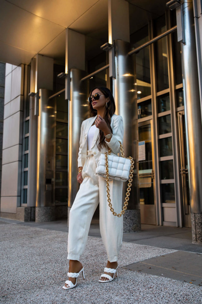 fashion blogger mia mia mine wearing a white linen suit from express