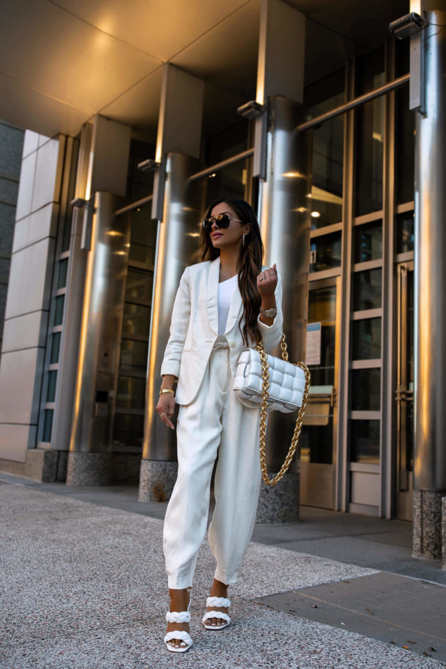 fashion blogger mia mia mine wearing a white suit for summer from express