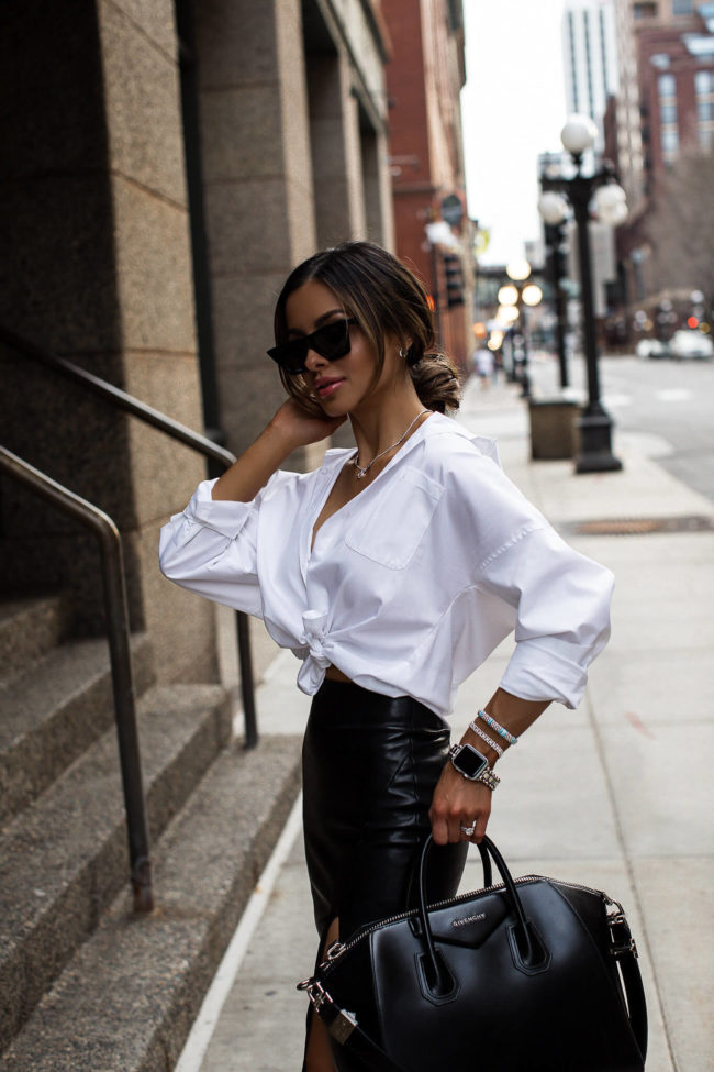fashion blogger mia mia mine wearing a white button up and leather skirt with lagos jewelry from nordstrom