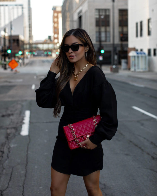fashion blogger mia mia mine wearing a black linen dress and a red chanel bag for spring