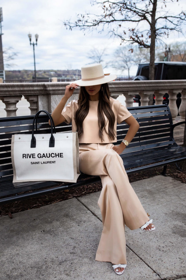 mia mia mine wearing a saint laurent rive gauche tote from saks fifth avenue