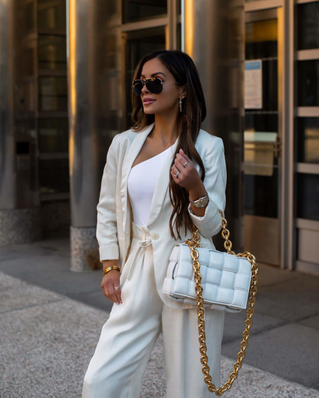 fashion blogger mia mia mine wearing a white linen suit from express