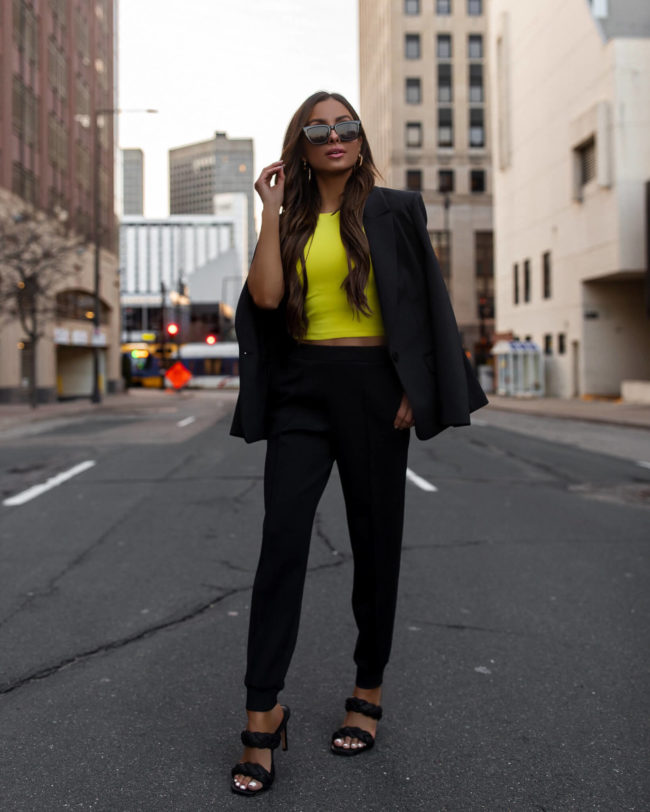 fashion blogger mia mia mia mine wearing an express neon top and black suit