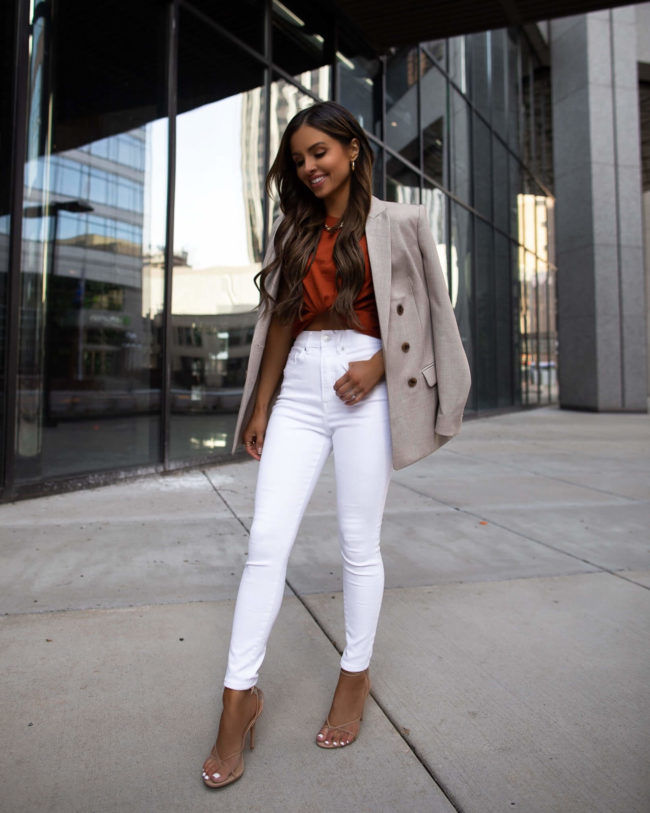 fashion blogger mia mia mine wearing white denim and an express blazer