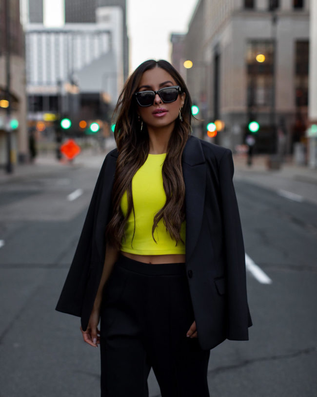 fashion blogger mia mia mine wearing a neon top from express