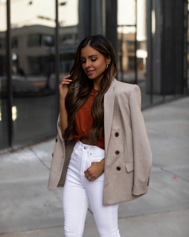 fashion blogger mia mia mine wearing a crop top and white denim