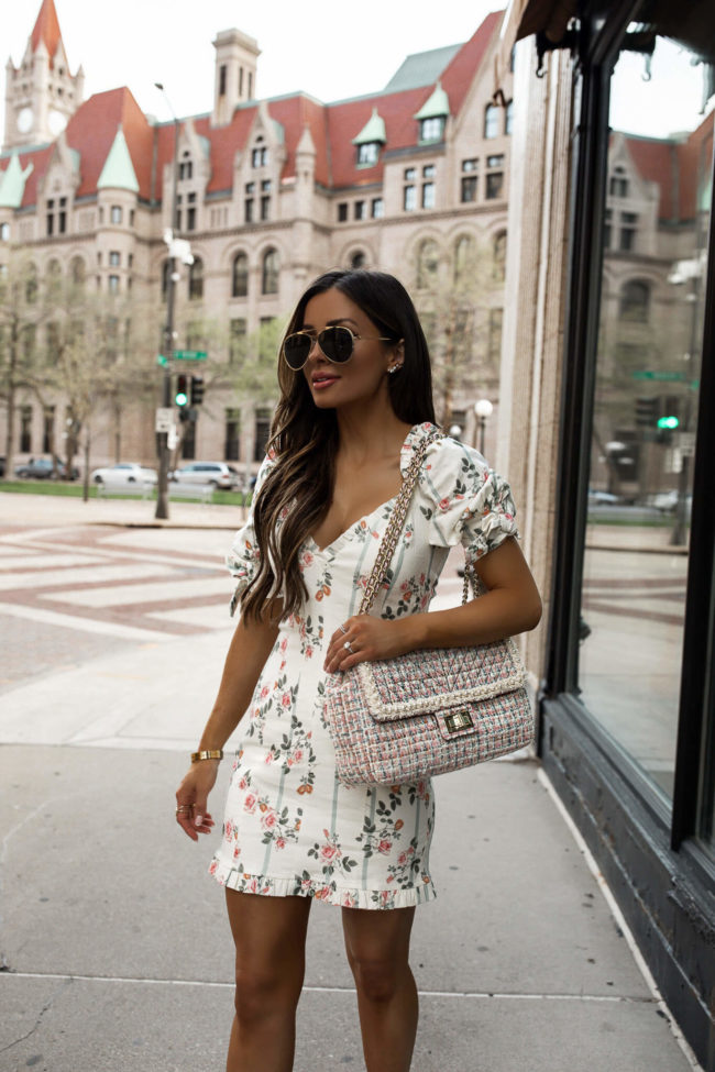 mia mia mine wearing a floral dress with a tweed bag by karl lagerfeld