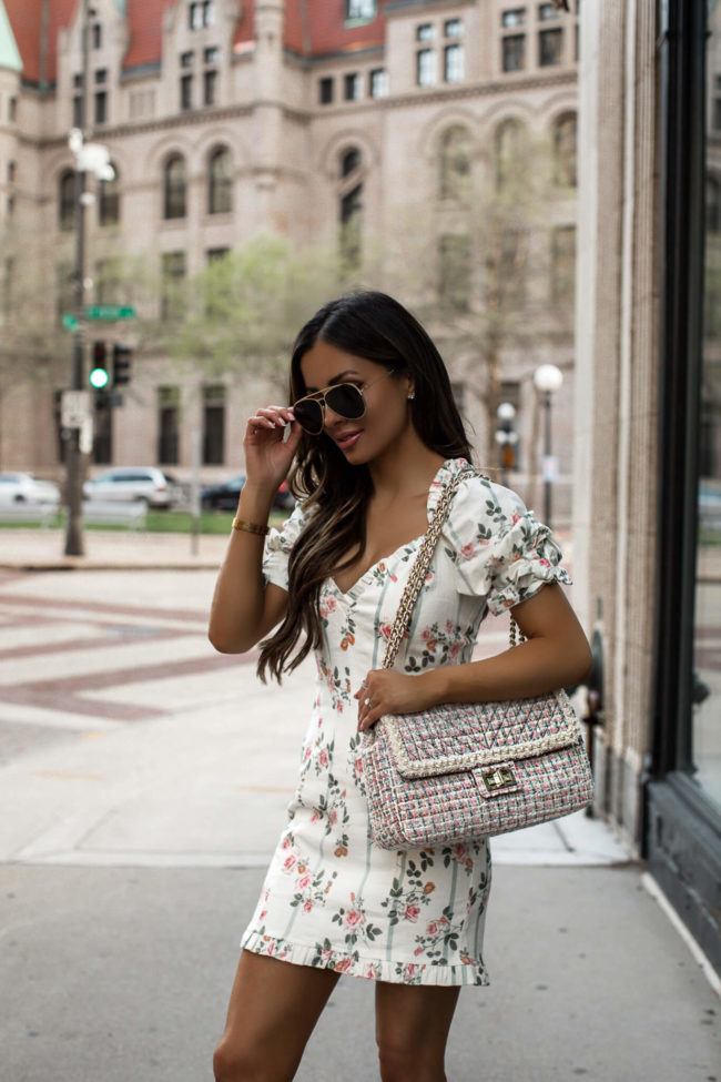 fashion blogger wearing a floral dress and pink tweed karl lagerfeld bag from saks off 5th