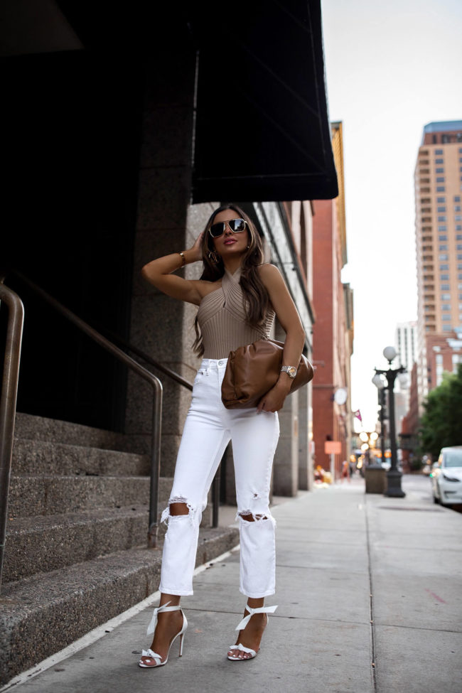 fashion blogger wearing a camel bodysuit and a bottega veneta bag