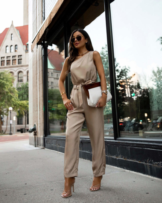 fashion blogger wearing a one shoulder jumpsuit from express for summer