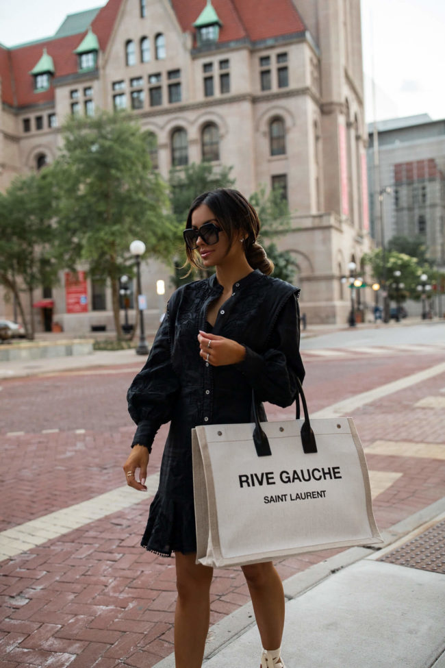 fashion blogger mia mia mine wearing a black veronica beard dress from saks fifth avenue