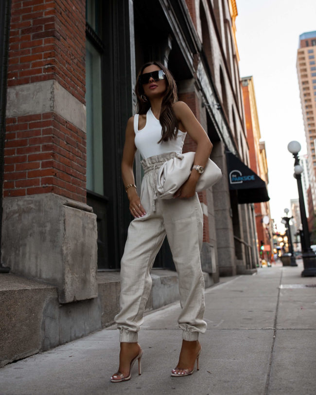 mia mia mine wearing linen pants and a bottega veneta pouch for summer
