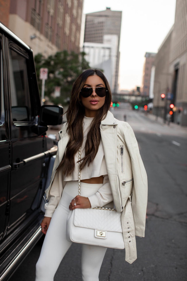 fashion blogger mia mia mine wearing a white workout outfit from saks off 5th on sale now