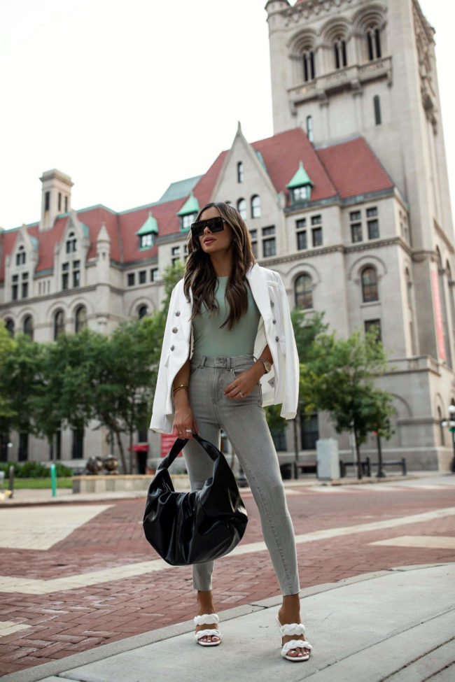 fashion blogger wearing gray denim and white heels from express