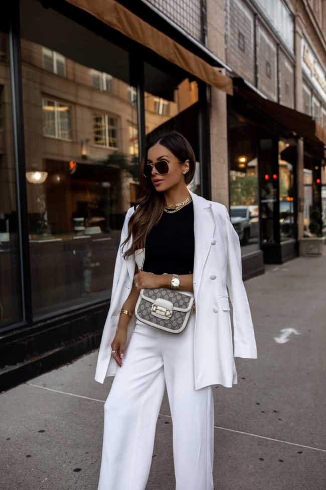 fashion blogger wearing a gucci mini horsebit 1955 bag with a white suit