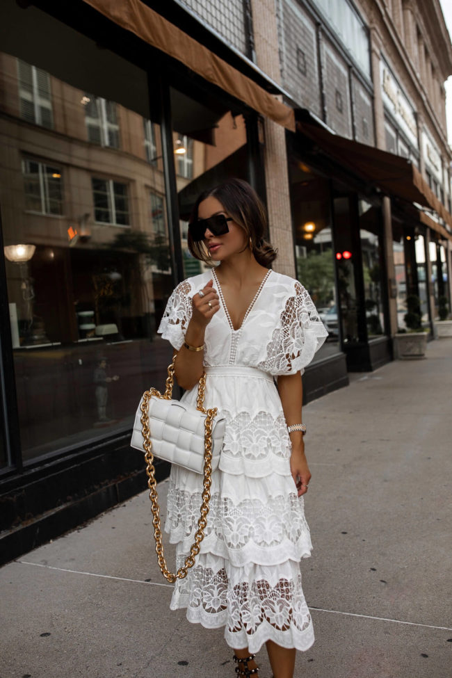 mia mia mine wearing a white lace dress and a white bottega veneta bag from neiman marcus