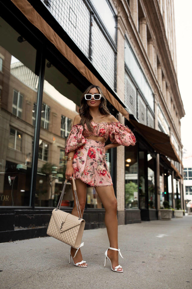 mia mia mine wearing a floral zimmermann set and a saint laurent envelope bag from saks fifth avenue