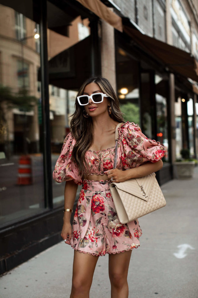 Fashion blogger mia mia mine wearing a floral set from zimmermann and a saint laurent envelope bag