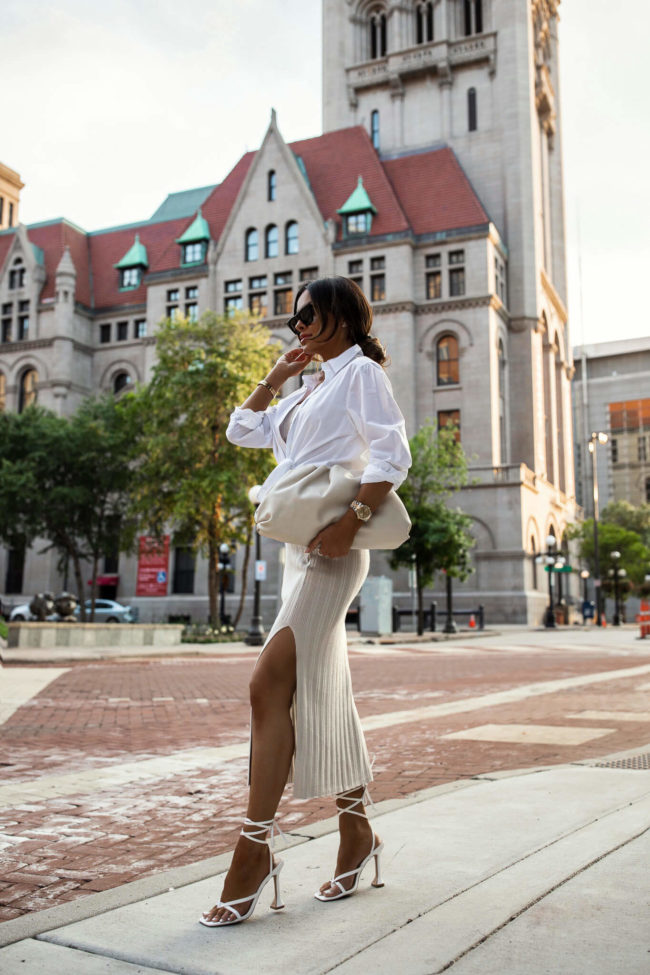 fashion blogger mia mia mine wearing a matching knit set with a white button down top