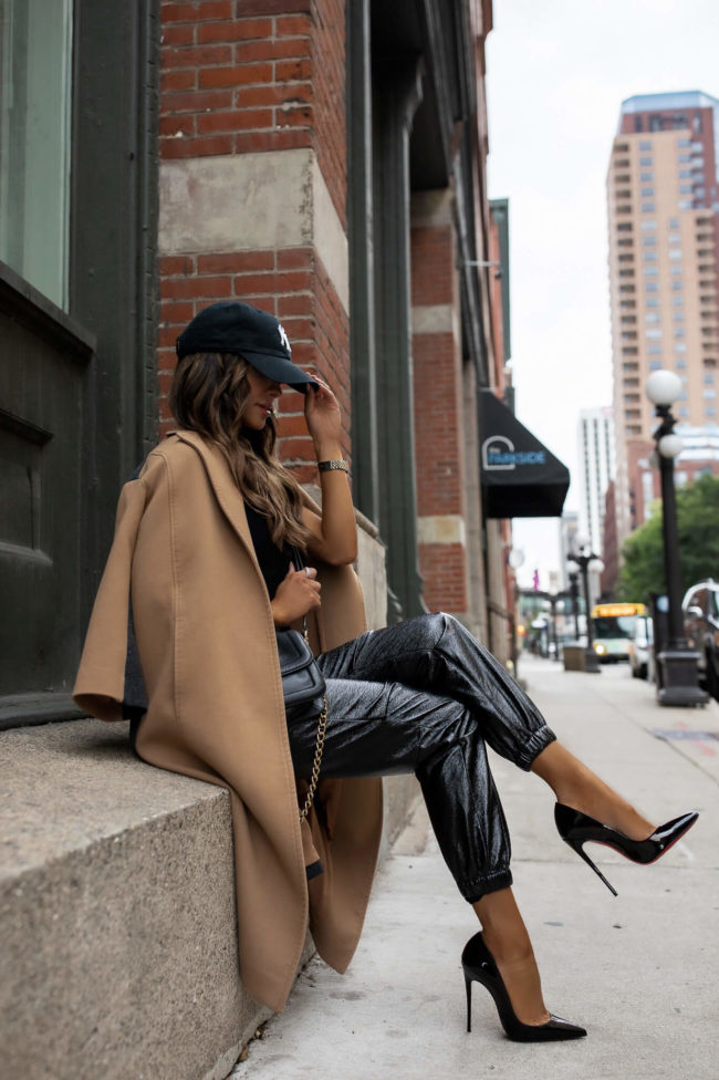 fashion blogger wearing a camel coat and jogger pants from rent the runway