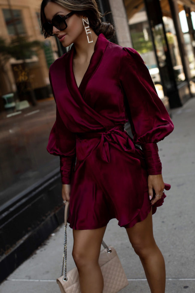 fashion blogger wearing a zimmermann silk mini dress in berry color 