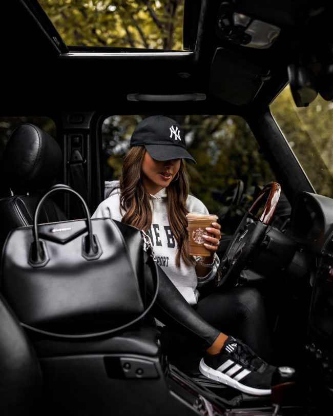 fashion blogger mia mia mine wearing adidas sneakers and an anine bing sweatshirt