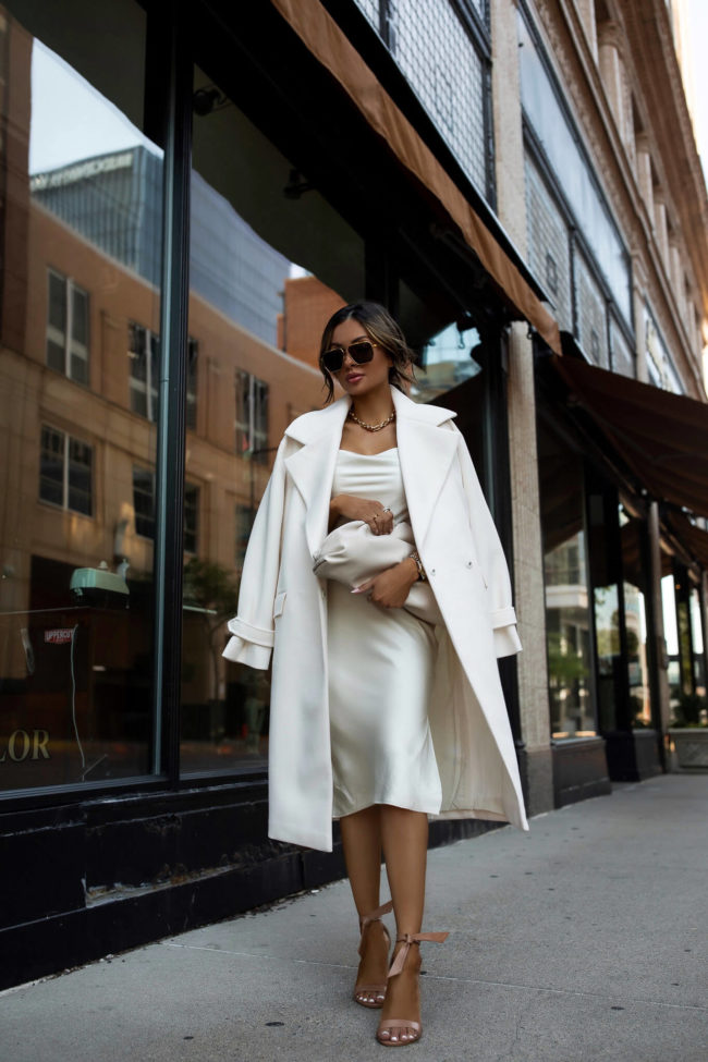 fashion blogger mia mia mine wearing a white silk dress from express and a white coat 