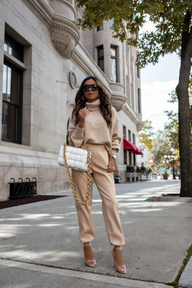 fashion blogger wearing camel leather joggers from neiman marcus