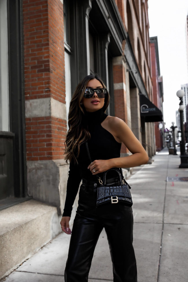 fashion blogger wearing a balenciaga hourglass crossbody bag