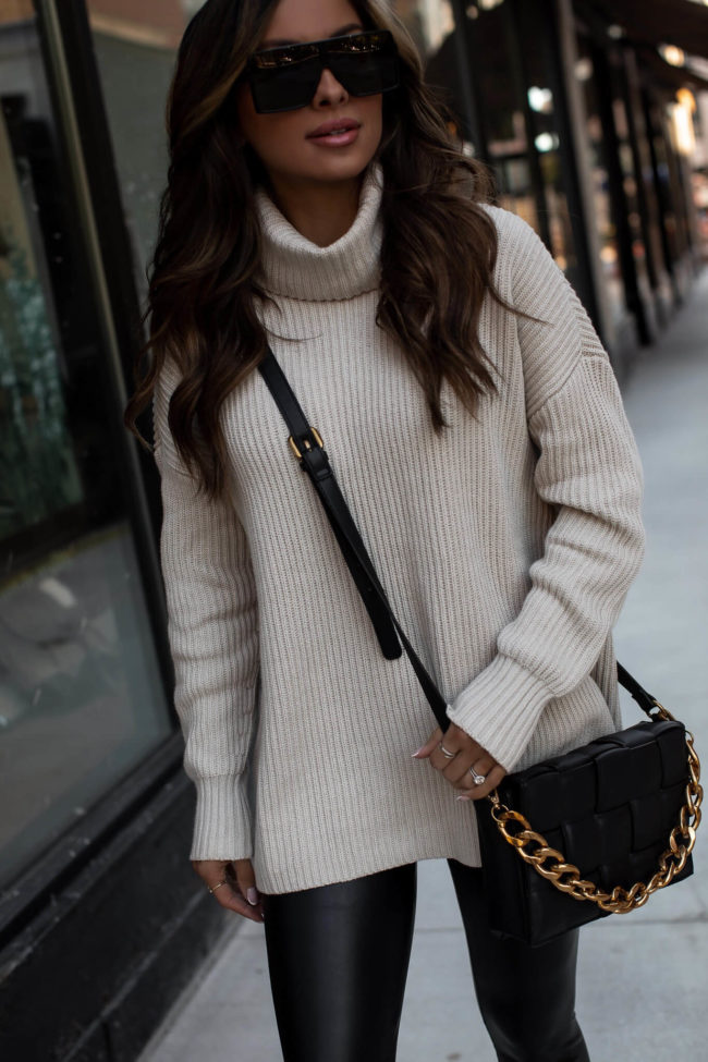 fashion blogger wearing a white sweater and bottega veneta similar bag