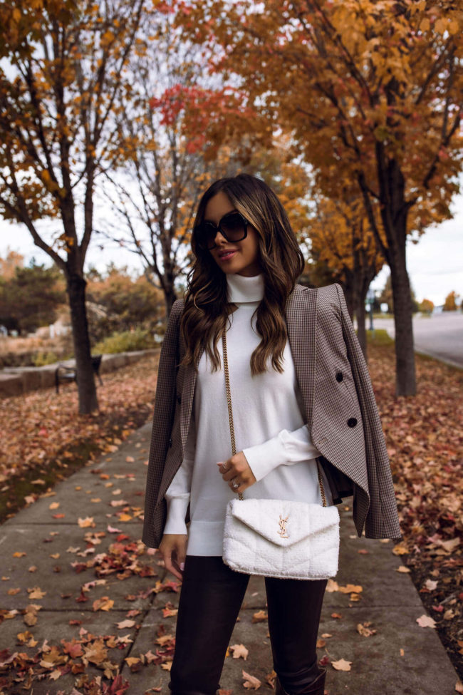 mia mia mine wearing a white puffer crossbody ysl bag from saks