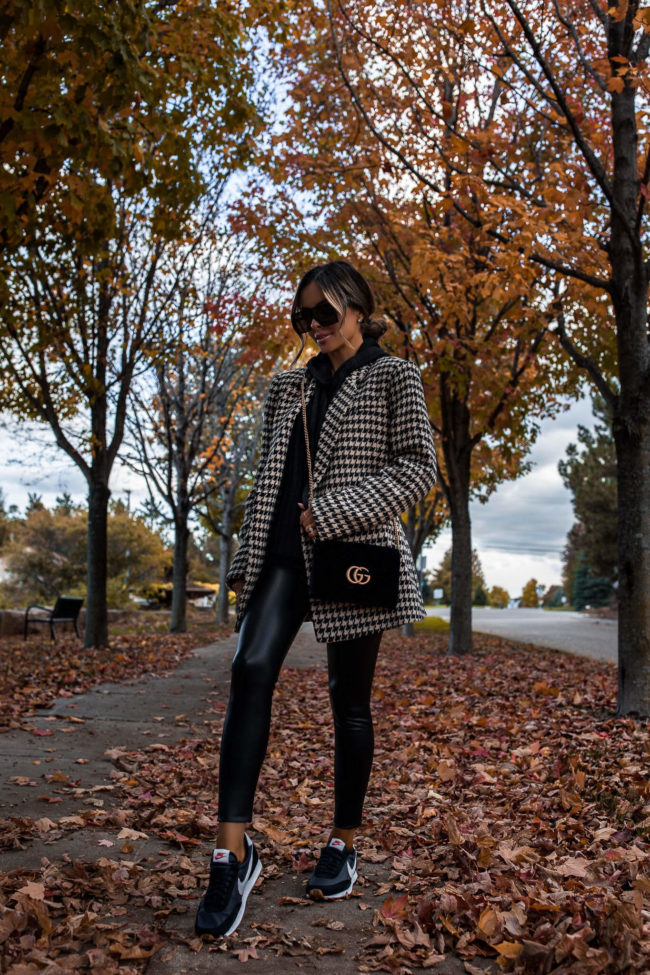 fashion blogger wearing a houndstooth blazer and commando faux leather leggings