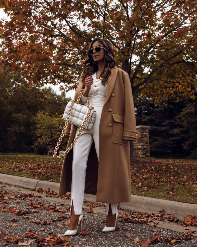 fashion blogger wearing a white outfit and a camel coat from karen millen